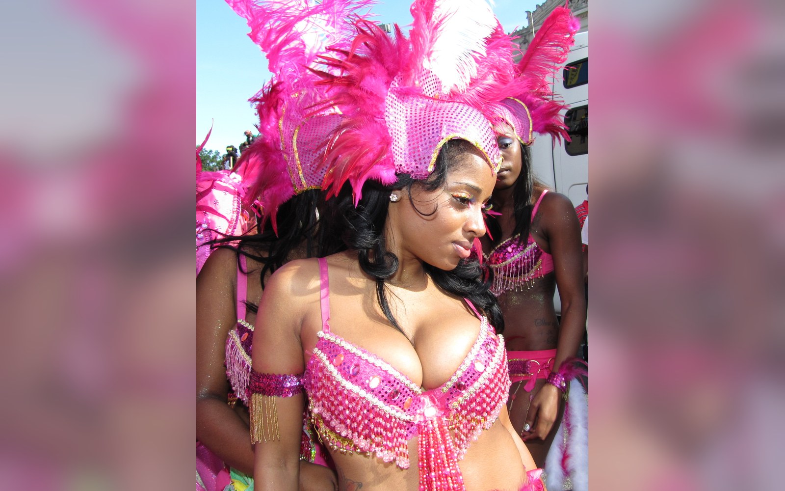 Carnival performers in pink feathered costume before the parade
